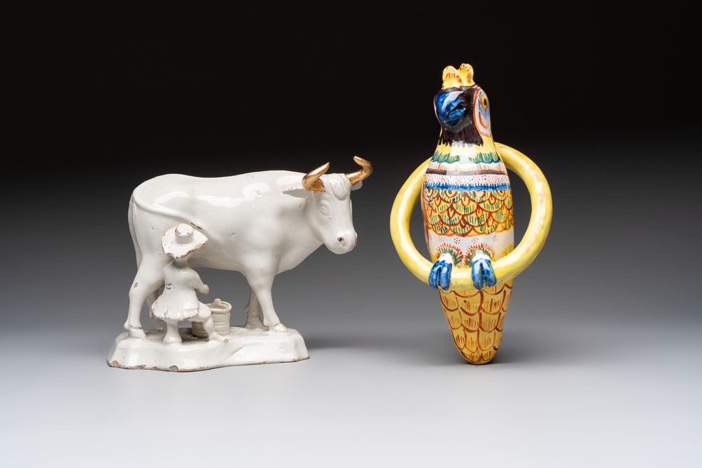 A white Dutch Delft cow milker group and a polychrome Dutch Delft parrot, 18/19th C.