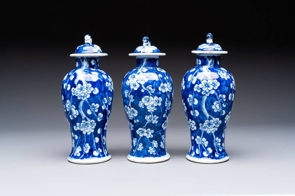 Three Chinese blue and white 'plum blossom' vases and covers, Kangxi mark, 19th C.