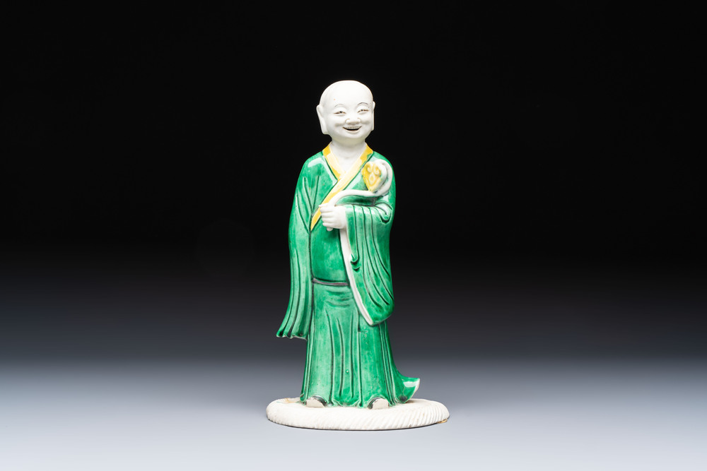 A Chinese verte biscuit Luohan holding a ruyi, Kangxi