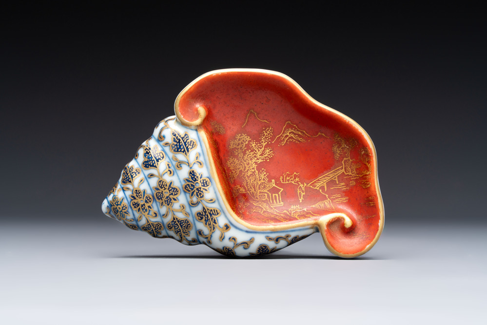 A Chinese blue, white and iron-red gilt-decorated conch-form ink palette with landscape design, Jiaqing mark and of the period
