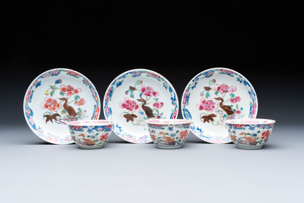 Three Chinese famille rose cups and saucers with a duck among flowering branches, Yongzheng/Qianlong