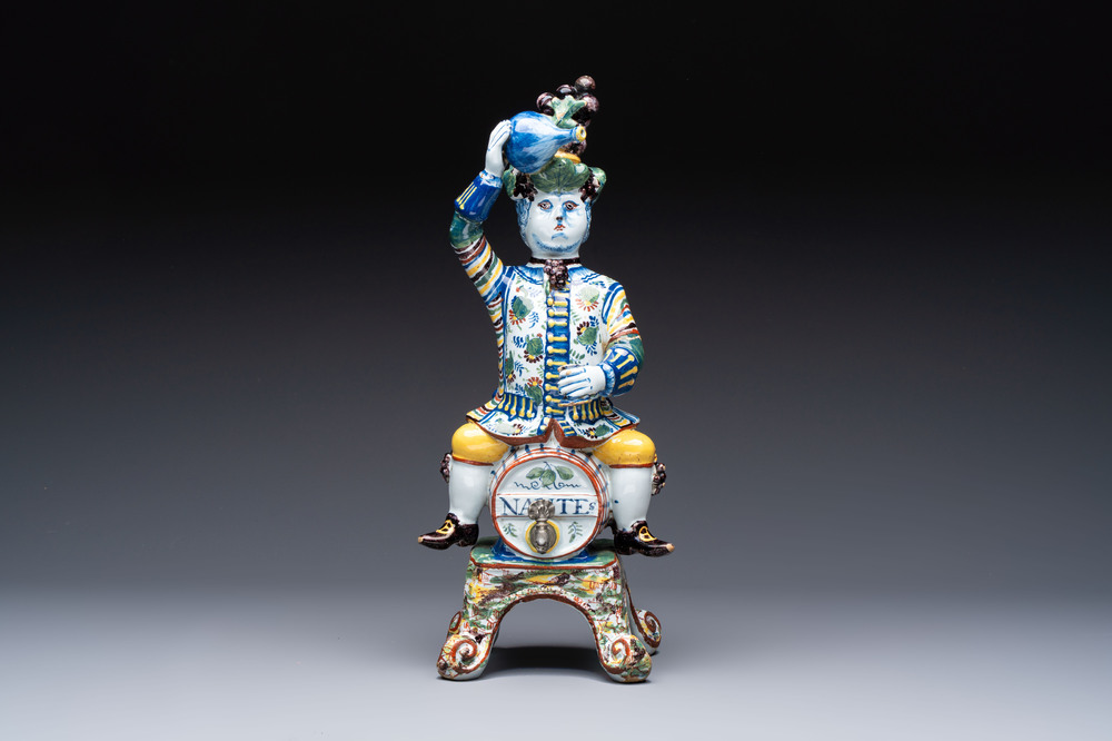 A rare polychrome Dutch Delft figural wine cistern and cover, 18th C.