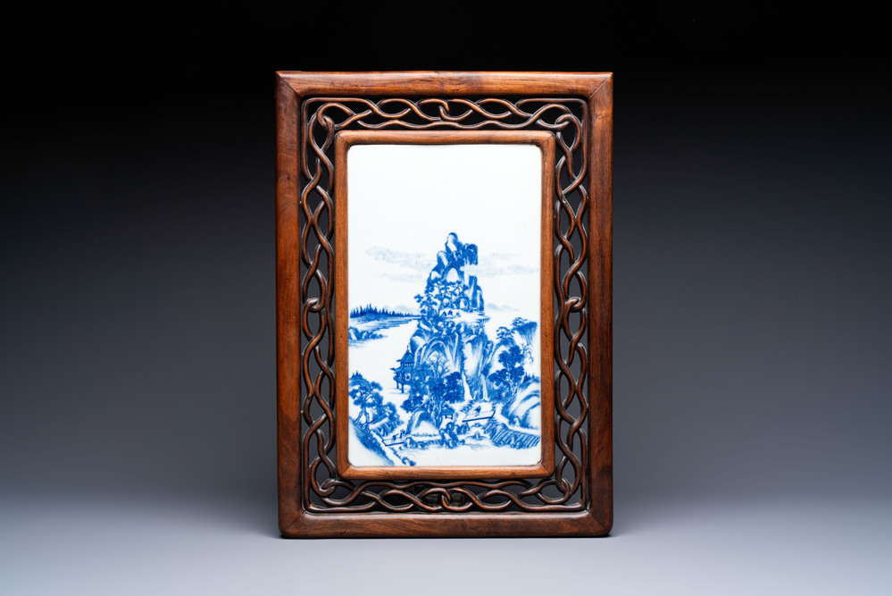 A Chinese blue and white 'mountainous landscape' plaque mounted in a wooden frame, 19/20th C.