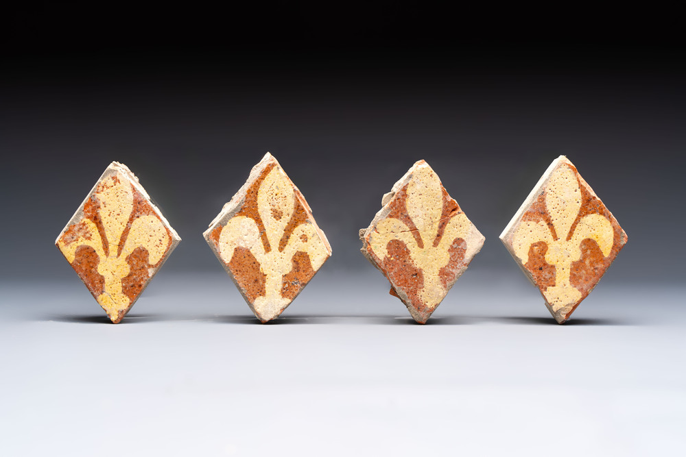 Four medieval slip-decorated &lsquo;Fleur-de-Lys&rsquo; tiles, France, 15/16th C.