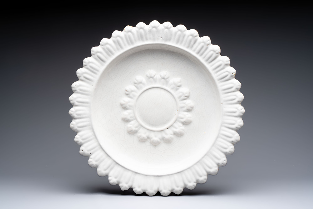 A large white-glazed Delftware 'sunburst' dish, France, 17th C.