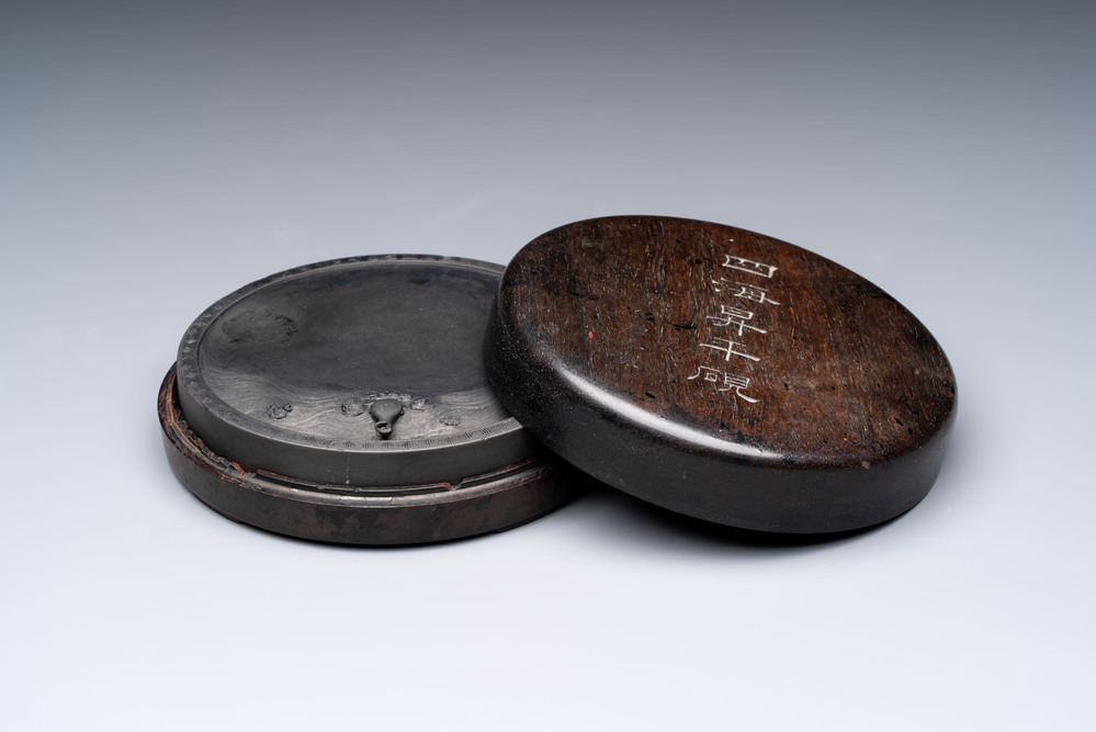 A Chinese carved circular Duan inkstone in a zitan box, signed Dong Jiaozeng 董教增, 18/19th C.