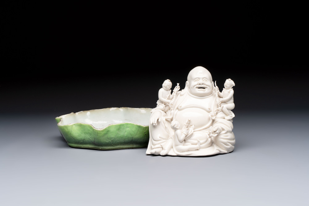 A Chinese green-enamelled lotus leaf-shaped brush washer and a Dehua blanc de Chine Milefo Buddha, 19th C