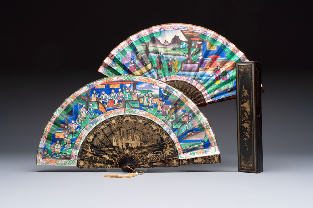 Two Chinese Canton gilt-lacquered and painted paper fans, one with its original box, 19th C.