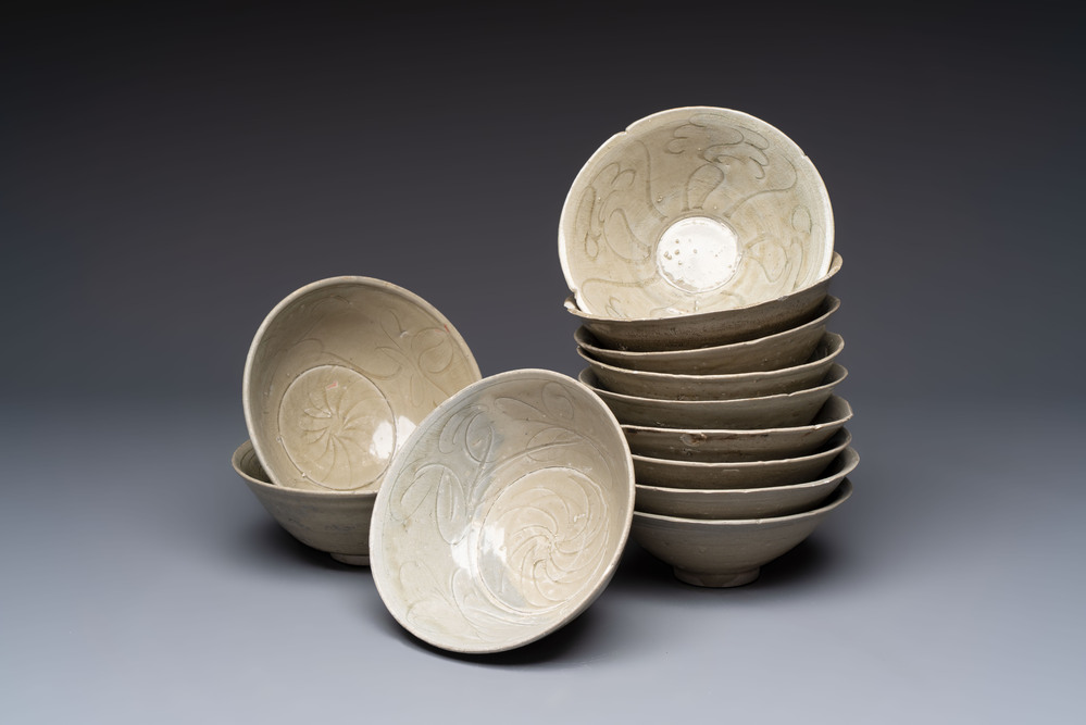 A group of 12 Chinese celadon-glazed bowls with incised floral design from the Jepara shipwreck, Fujian kilns, Song