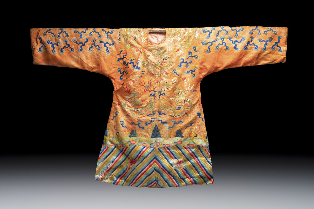 A Chinese embroidered silk salmon-ground 'dragon' robe, 19th C.