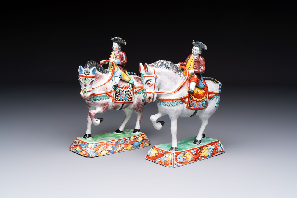 A pair of polychrome Dutch Delft petit feu models of horses with riders, 18th C.
