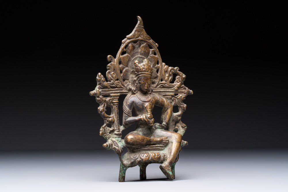 A Tibetan or Nepalese bronze seated Tara holding a vajra, 12/13th C.