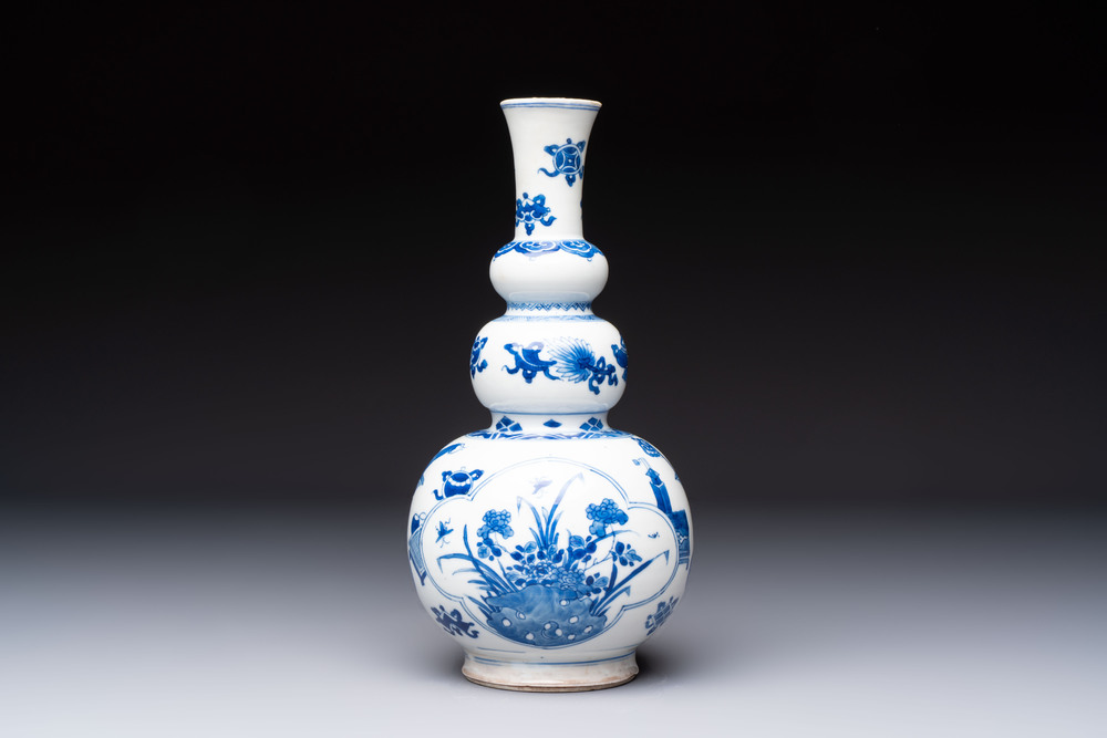 A Chinese blue and white double gourd 'Antiquities' vase, Kangxi