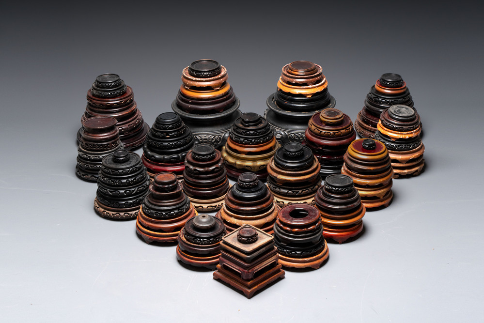 A large collection of 100 Chinese wooden stands, 19/20th C.