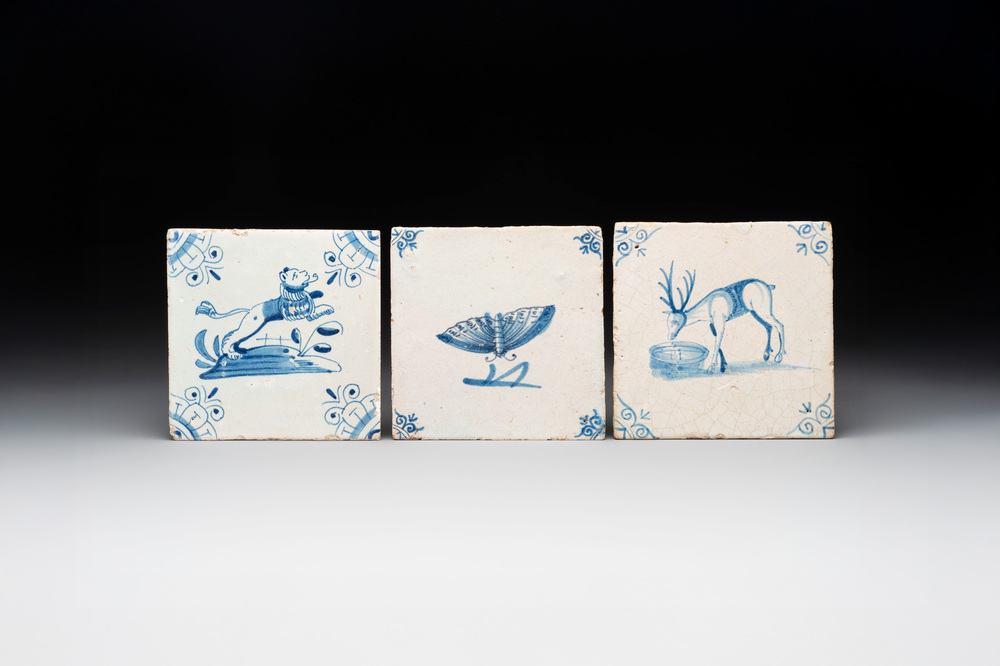 Three blue and white Dutch Delft tiles with a lion, a butterfly and a deer, 17th C.