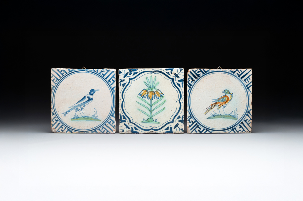 Three polychrome Dutch Delft 'flower' and 'bird' tiles, 17th C.