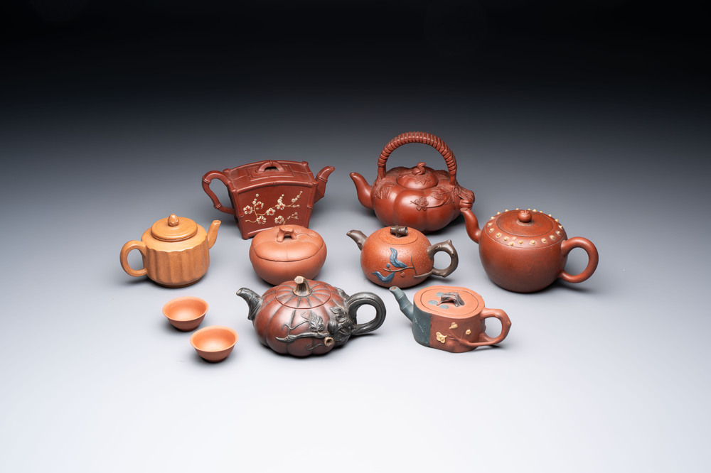 Seven Chinese Yixing stoneware teapots, two cups and a covered box, 20th C.