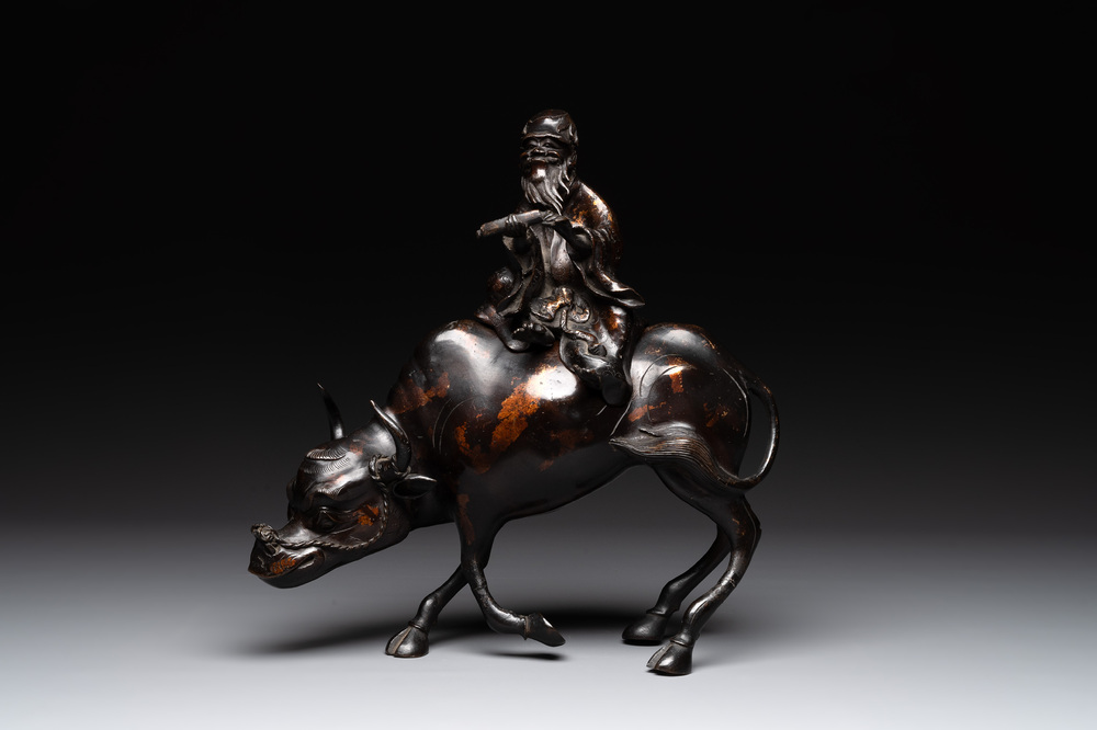 A Japanese gold-splashed bronze incense burner in the shape of an immortal riding a buffalo, ​​Kin San Sō On 金産宗音製造 mark, Meiji, 19th C.