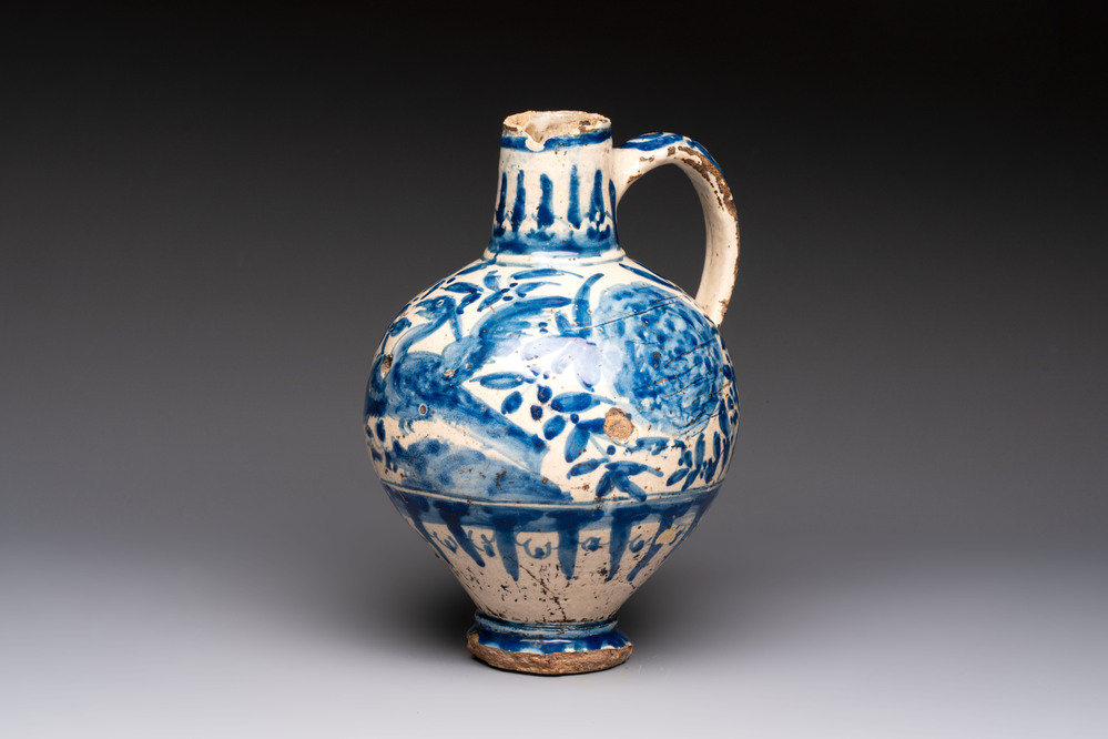A blue and white Portugese faience jug with a bird among flowering branches, 17th C.