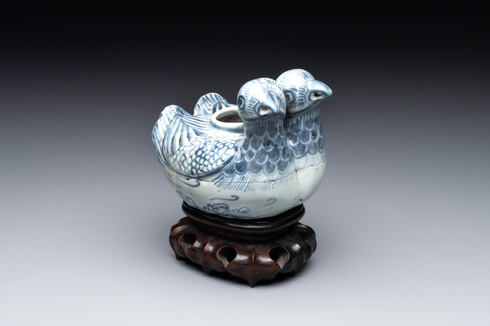 A Chinese blue and white 'double mandarin duck' ewer or water dropper on wooden stand, Ming, ca. 1500
