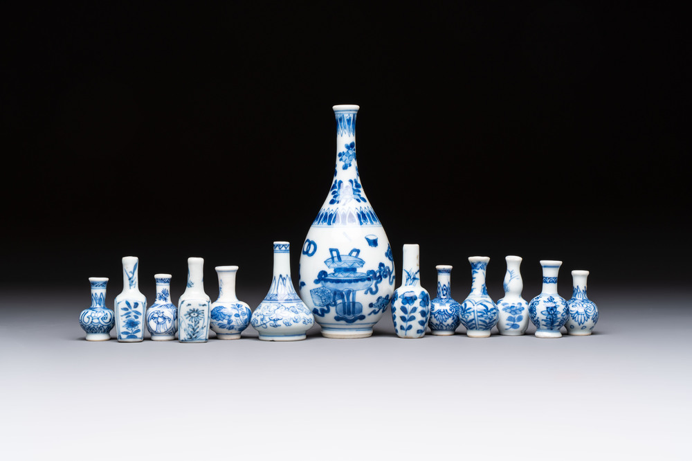 A group of 12 Chinese blue and white miniature vases and a small bottle vase, Kangxi