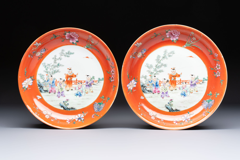 A pair of Chinese famille rose coral-ground 'Playing Boys' plates, Jiaqing marks, Republic
