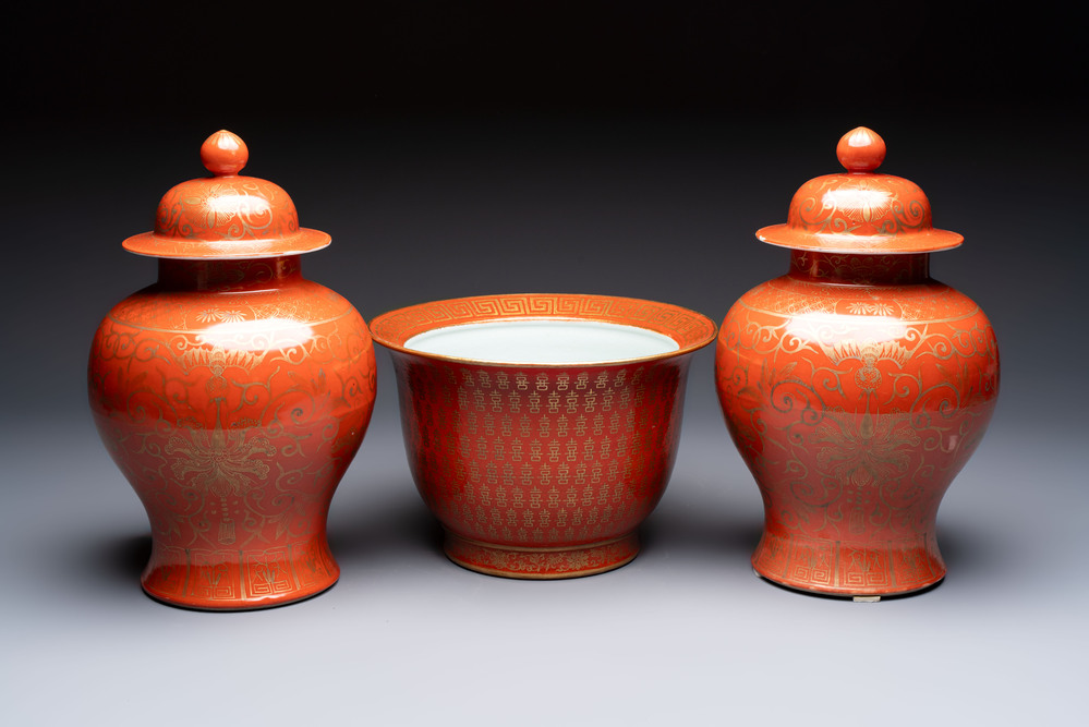 A pair of Chinese gilt-decorated coral-ground covered vases and a 'Double Happiness 囍' jardini&egrave;re, 19th C.