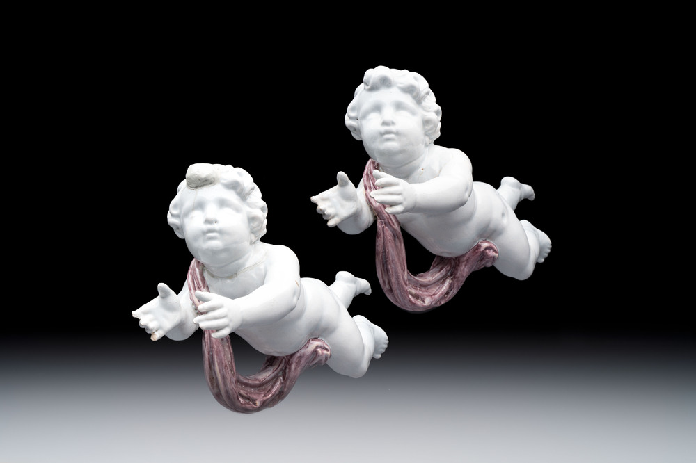 A pair of manganese and white Delftware putti, France or Germany, 19th C.
