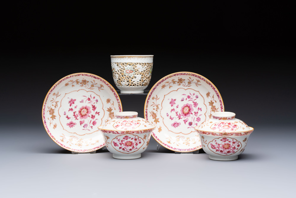 A pair of Chinese famille rose gilt-decorated covered cups and saucers and an openworked cup, Qianlong