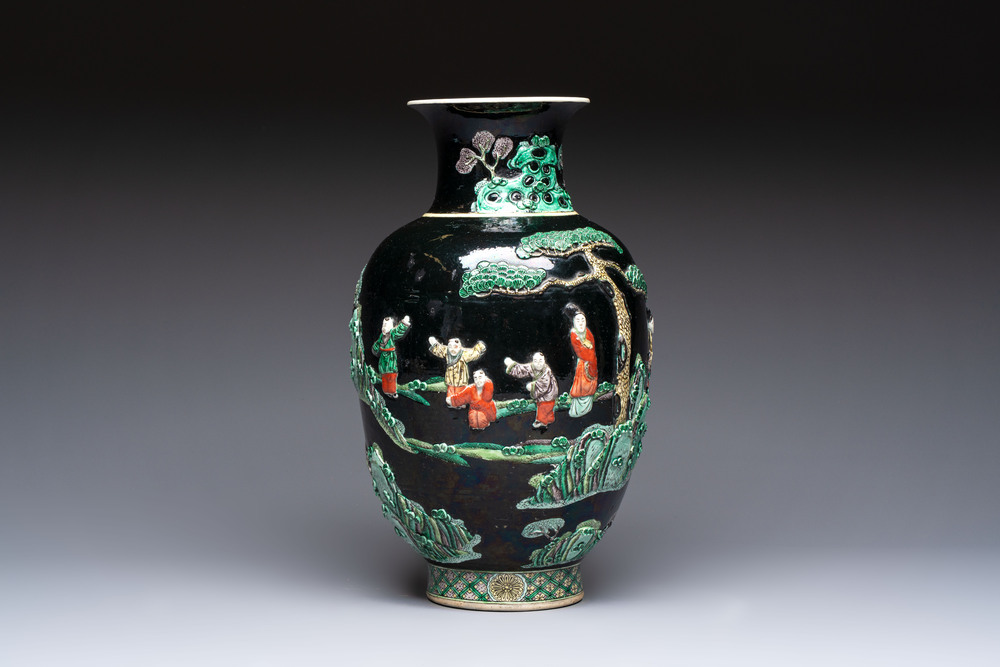 An unusual Chinese famille noire vase with relief design, Kangxi mark, 19th C.
