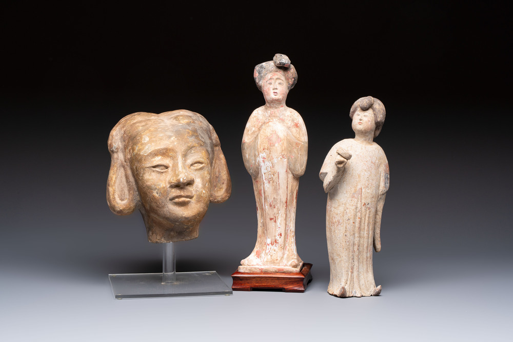 Two Chinese polychrome pottery figures and a female head, Tang