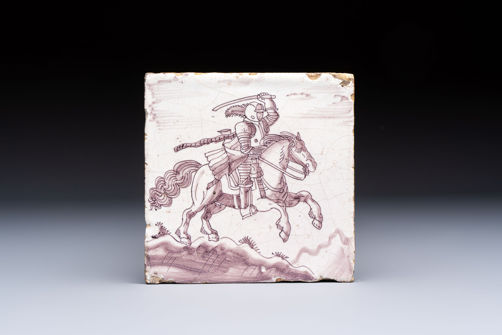 A very unusual manganese Dutch Delft 'Knight on Horseback in Open Air' tile, late 17th C.