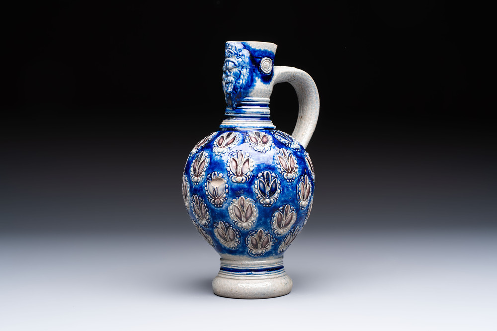 A Westerwald stoneware jug with a lion's head and moulded floral design, Germany, 17th C.