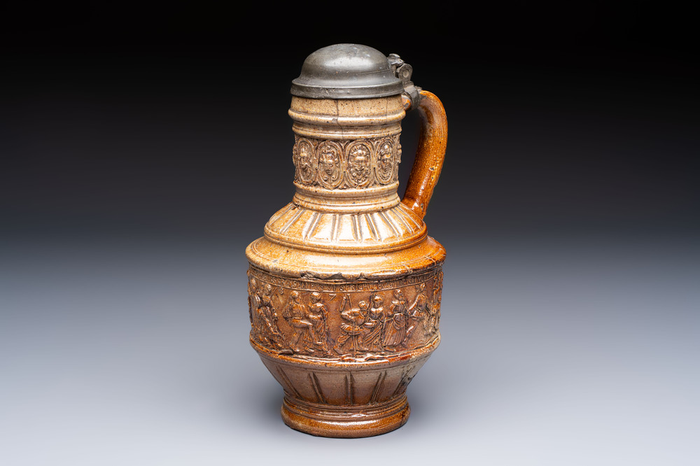 A Raeren stoneware 'Peasants Dance' jug with a mounted pewter lid, dated 1587