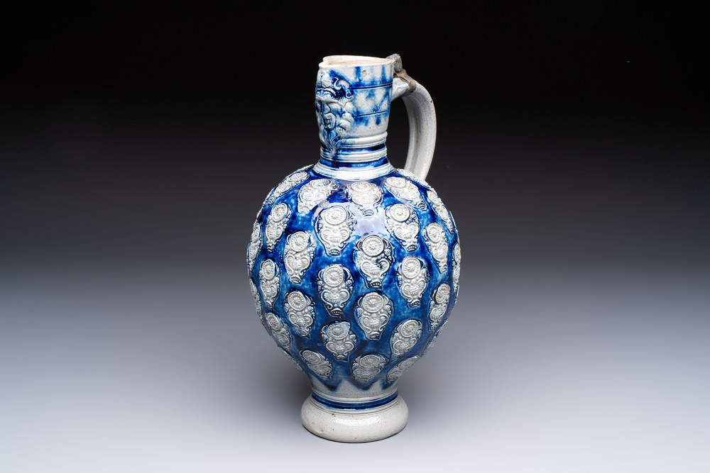 A Westerwald stoneware jug with a lion's head and moulded floral design, Germany, 17th C.