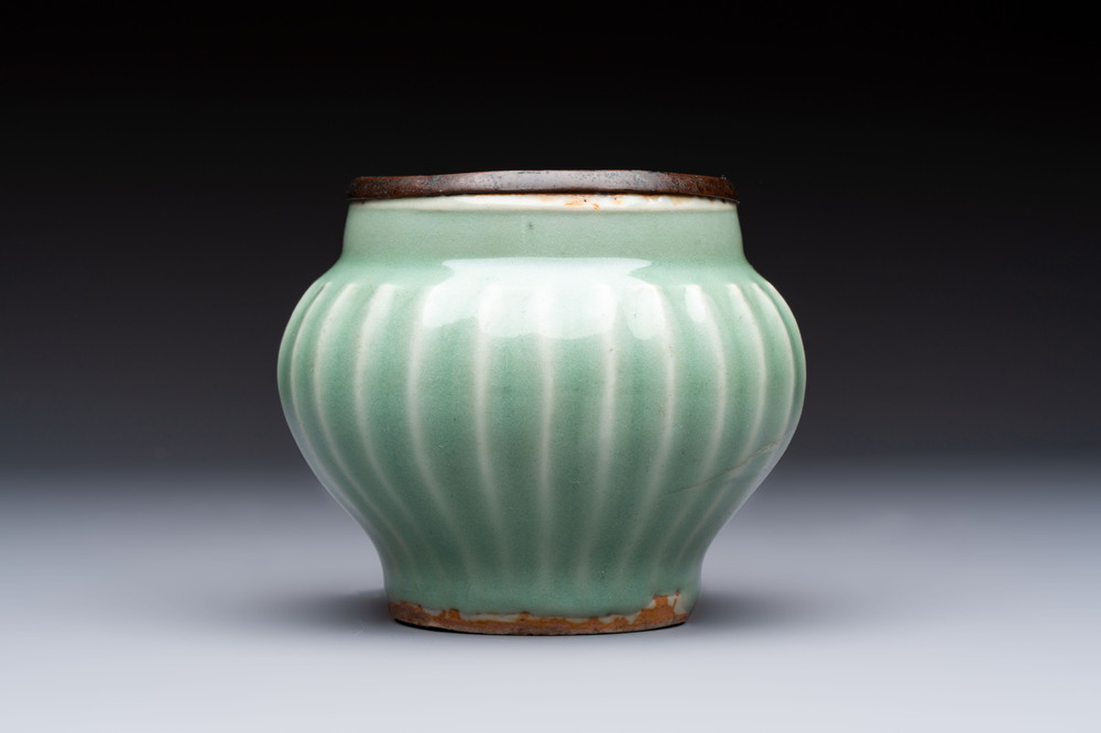 A Chinese Longquan celadon 'Lotus' jar with bronze mount, Song
