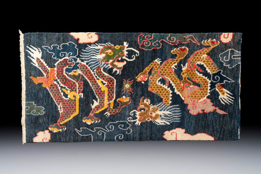 A Tibetan woollen &lsquo;Dragons Chasing the Flaming Pearl&rsquo; carpet, 19th C.