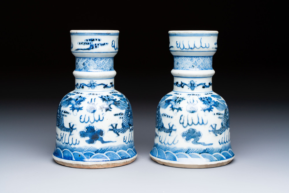 A pair of Chinese blue and white 'Dragons Chasing the Flaming Pearl&rsquo; candlesticks, 19th C.