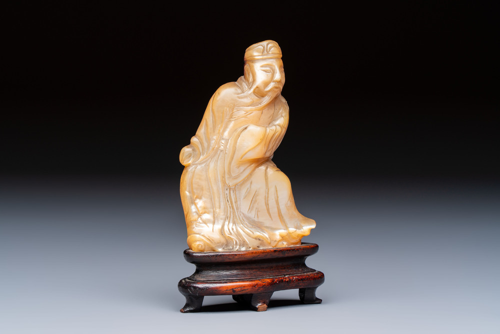 A Chinese carved mother-of-pearl figure of an official on wooden stand, 18/19th C.