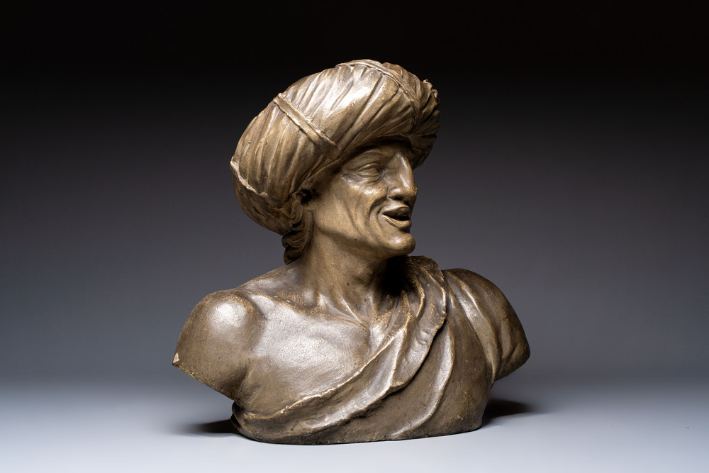 A large patinated terracotta bust of a smiling Oriental man, 18/19th C.