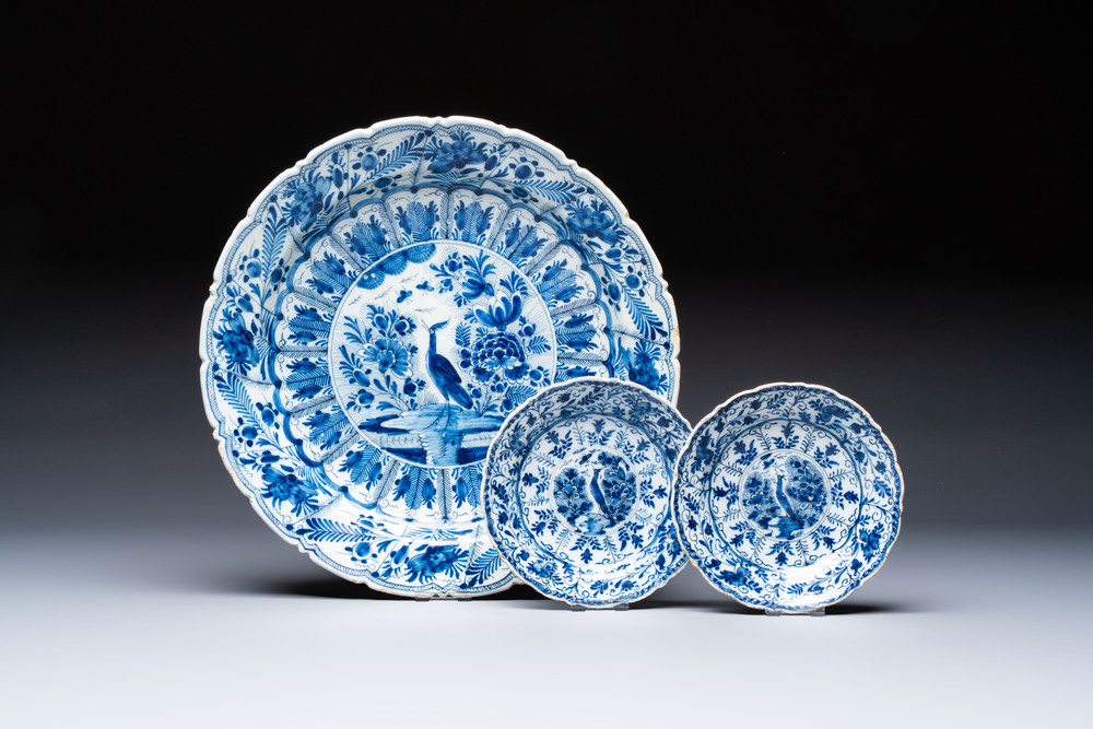 A pair of blue and white Dutch Delft 'Cranes' plates and a dish, 18th C.
