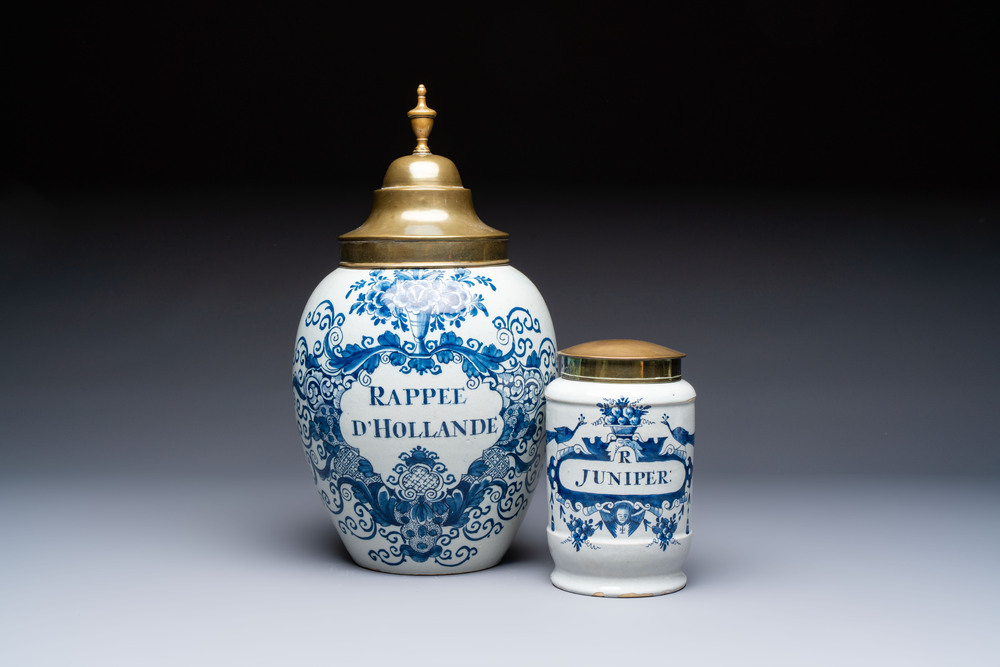 A blue and white Dutch Delft tobacco jar and a drug jar with brass lids, 18th C.