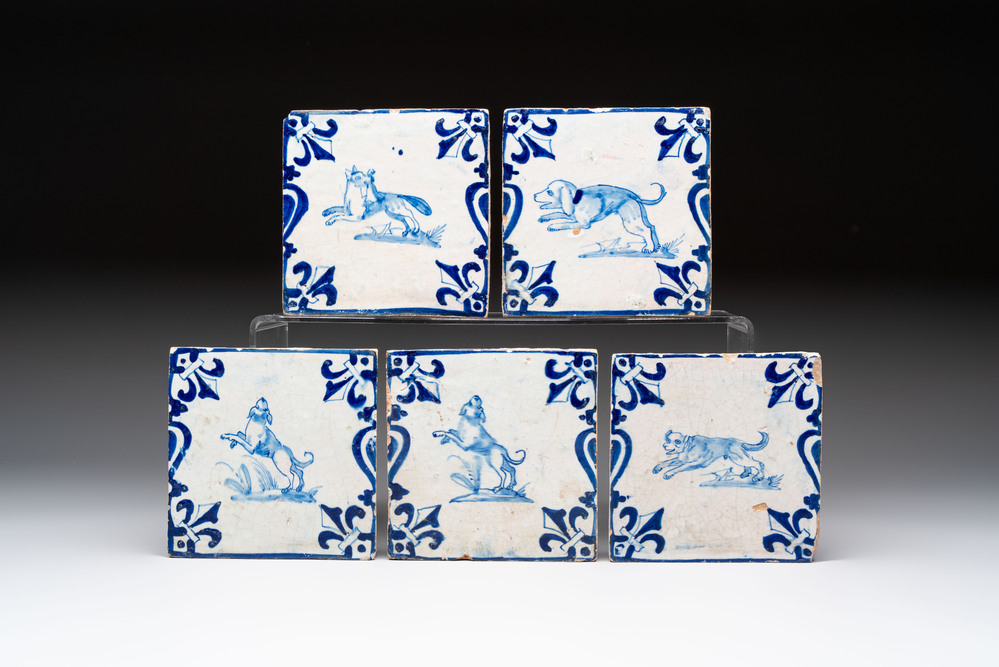 Five blue and white Dutch Delft 'Candelabra' tiles with dogs and a fox, 17th C.