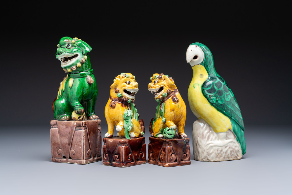 Three Chinese sancai-glazed Buddhist lions and a parrot, 19th C.