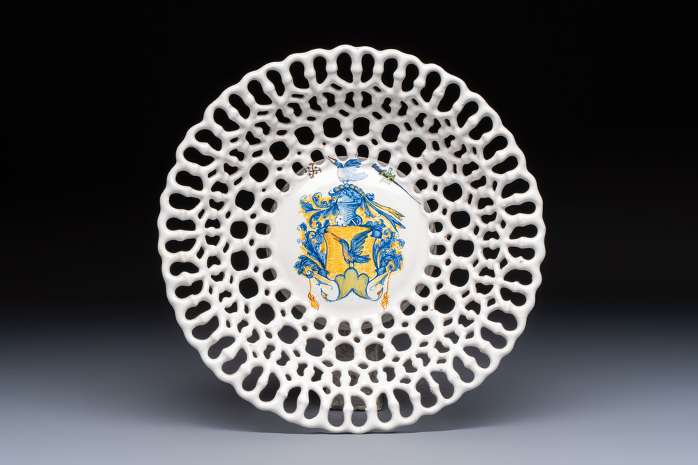 A polychrome Italian maiolica armorial reticulated basket, workshop of Virgiliotto Calamelli, Faenza, 16th C.