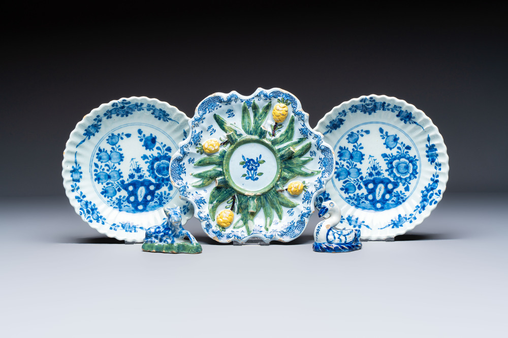 Two polychrome Dutch Delft miniature models of animals, a 'Pineapple' stand and a pair of blue and white plates, 18th C.