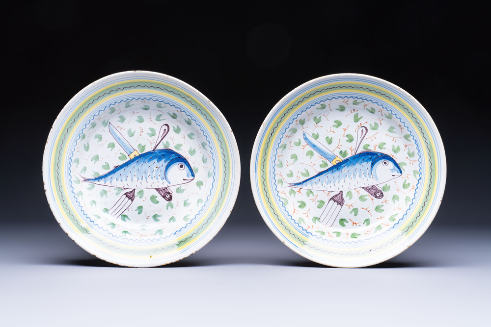 A pair of unusual polychrome Brussels faience plates with fish and cutlery, 18th C.