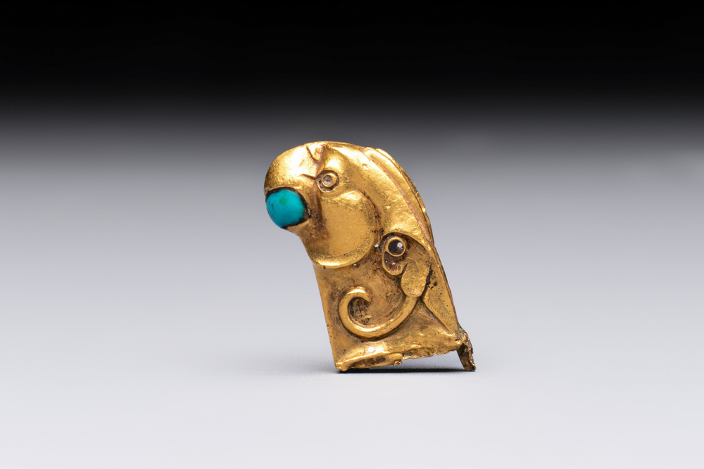 A rare Chinese turquoise- and glass-inlaid gold fitting in the form of a parrot, Han