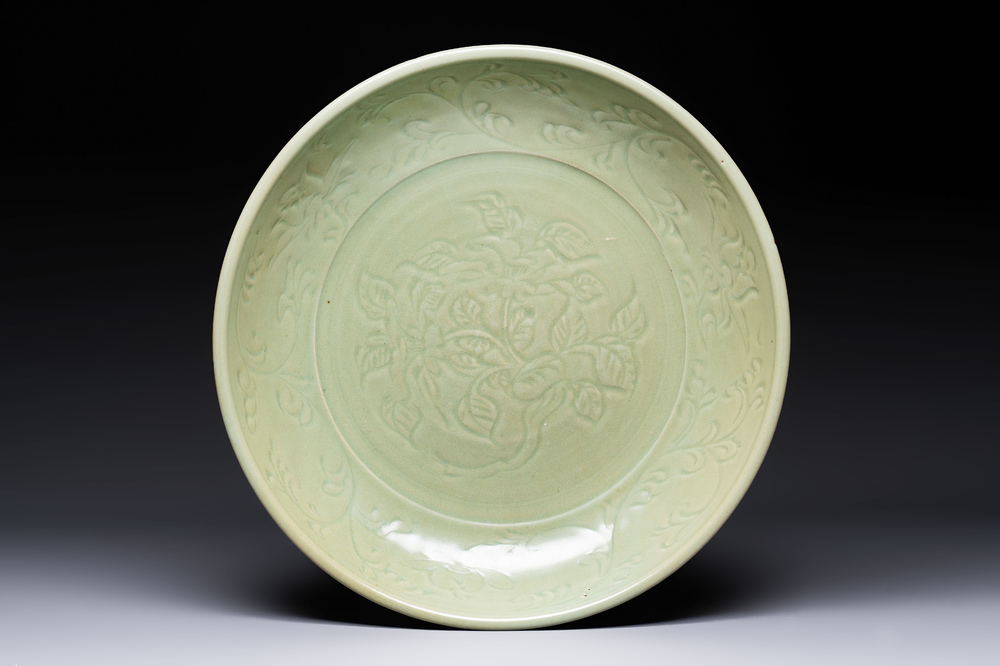 A rare and large Chinese Longquan celadon dish with floral design, Ming, early 15th C.