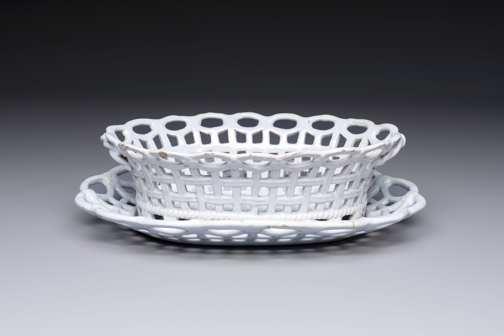 A rare white-glazed Brussels faience reticulated basket on stand, 18th C.